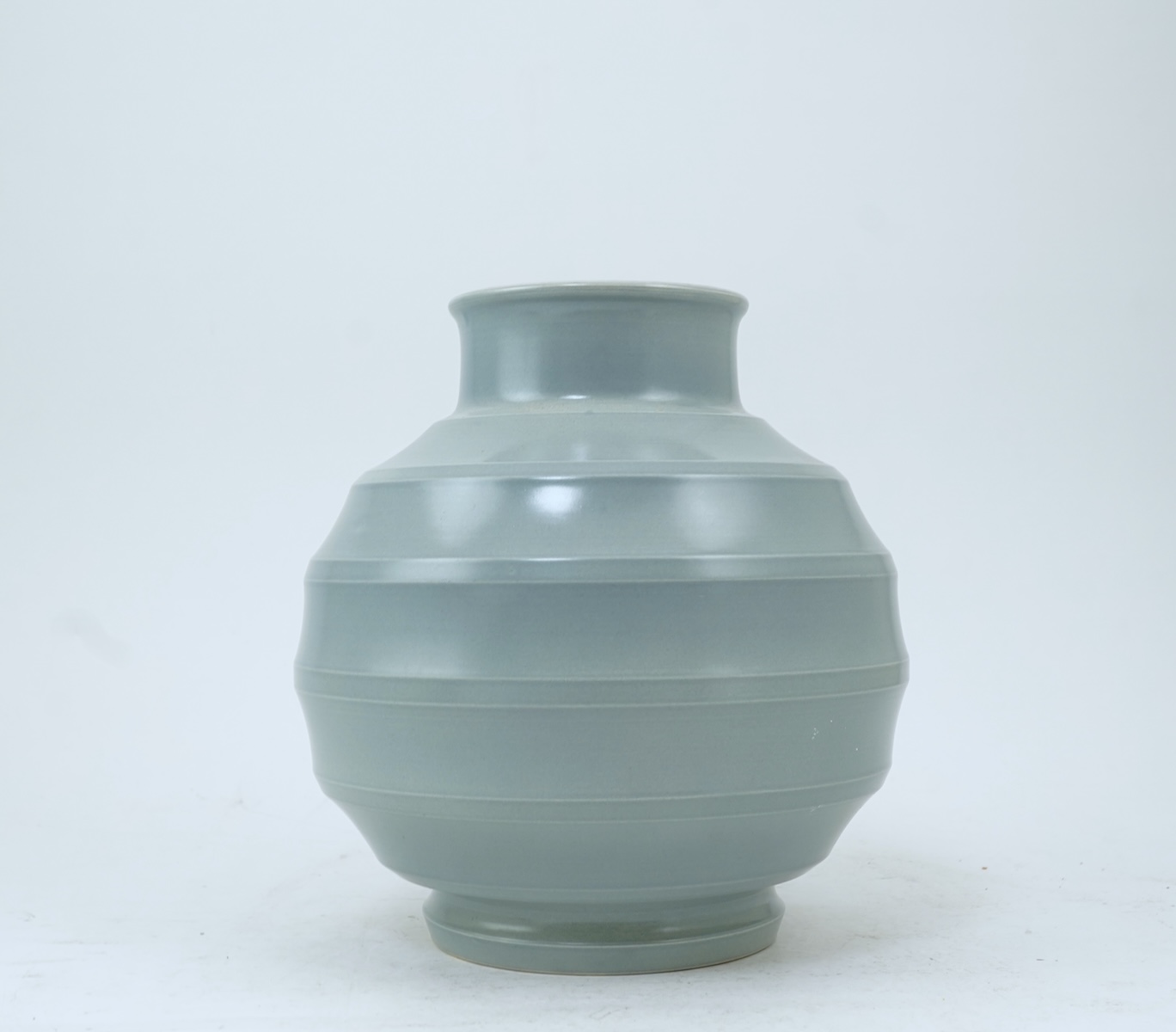 Keith Murray MC RDI FRIBA (New Zealand/British, 1892-1981) for Wedgwood: A pale blue glazed globe or 'bomb' vase